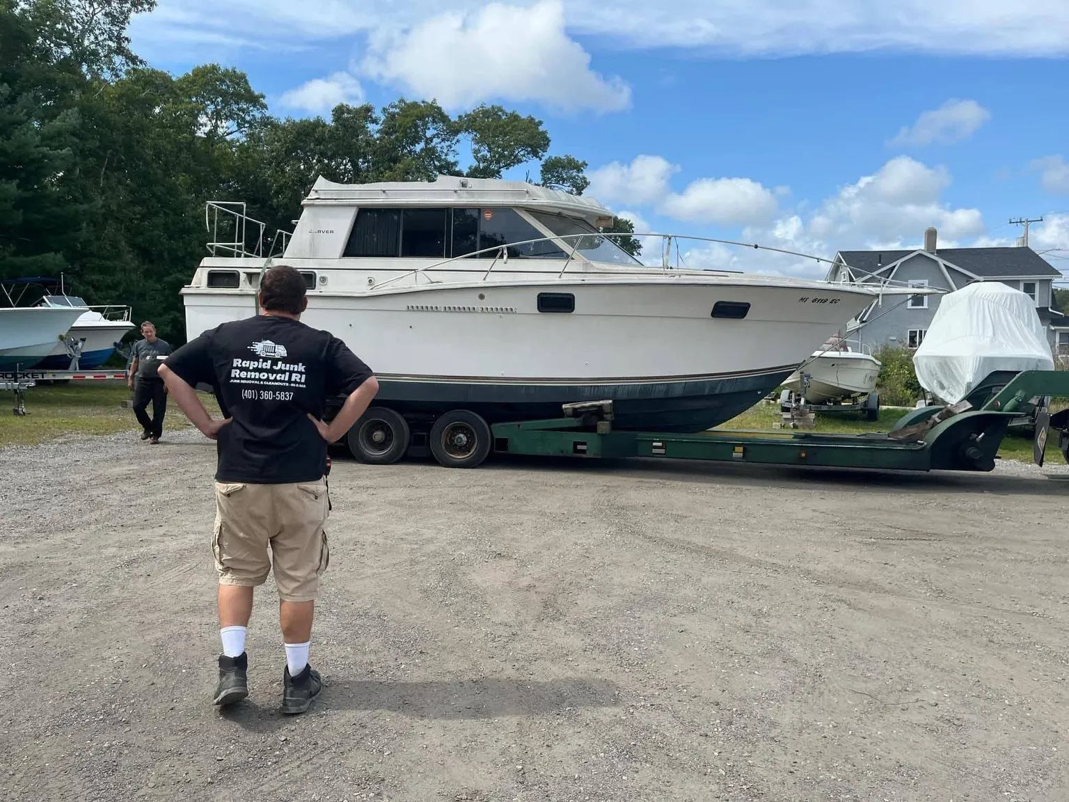 Rapid Junk Removal RI hauling a boat in Warwick, Rhode Island with a hydraulic boat trailer.