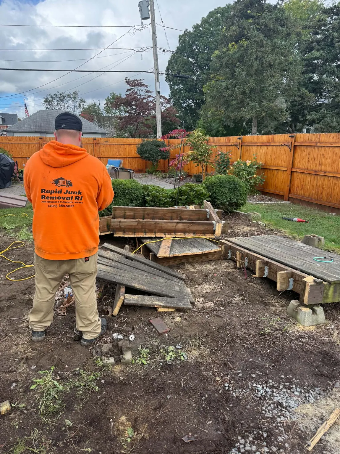 Rapid Junk Removal RI crew demolishing and removing a wooden deck in Providence, Rhode Island.