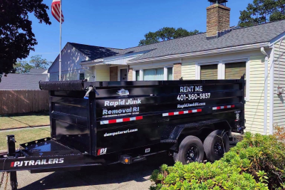 Black Rapid Junk Removal RI 15-yard driveway-friendly dumpster rental delivered on a residential driveway in Rhode Island